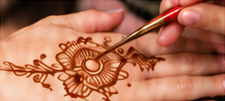 Detailed henna design being applied to a hand